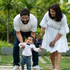 A slightly different angle from the same outdoor session, this image captures the pure delight on the parents' faces. It shows how I work to get a variety of shots that tell the complete story of your family's interaction during the photoshoot.