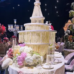 For a table design exhibition, we created this "Lace Love" concept. The centerpiece is a magnificent chandelier-like structure made of thousands of pearls and beads, surrounded by soft pastel florals, showcasing our love for intricate, detailed craftsmanship.