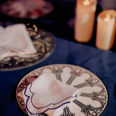 A custom-designed dinner plate featuring Gothic arch motifs, perfectly matching the theme of the 'Palace Ball' Sangeet. Even the tableware was part of the story.