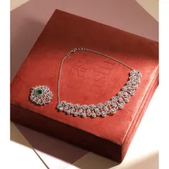 The Diamond Willow necklace shown with its pendant detached. This highlights the two separate pieces, the simpler necklace and the ornate brooch-like pendant, which can be worn independently.