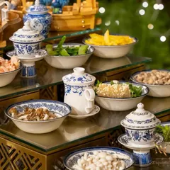 A vibrant display of fresh ingredients for our live Teppanyaki station. We offer a wide selection of vegetables, seafood, and meats for guests to customize their meal, all presented in beautiful blue and white porcelain.