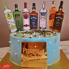 A fun and popular cake for a husband's birthday or a bachelor party. This cake is customized with edible toppers of various miniature liquor bottles like Jack Daniel's, Smirnoff, and Absolut Vodka.