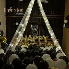 Create a romantic surprise with a canopy of lights and balloons over the bed. This intimate setup is perfect for a spouse's birthday or an anniversary.
