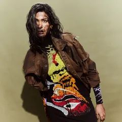 A powerful, edgy look from the Huemn show, with a hand-painted dress and a distressed leather jacket.