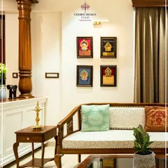 I believe a home should be a canvas for our cultural legacy. This living room is inspired by the timeless elegance of Kerala's architecture, featuring a traditional carved wooden sofa, a stately pillar, and a curated gallery of Tanjore paintings. It’s a space that feels both luxurious and deeply rooted in Indian heritage.