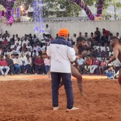 A tense moment during a Kusti bout. I stay close to the action, observing technique and providing real-time feedback to my wrestlers.