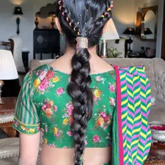 A playful and colorful braid perfect for a Mehendi or Haldi ceremony. I wove multi-colored threads into a classic braid and added a crown braid for extra detail, creating a fun and youthful look.