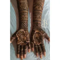 A divine love story for a bridal design. This piece features beautiful portraits of Radha and Krishna on the palms, surrounded by traditional elephant motifs and detailed patterns.