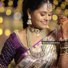 A happy, smiling shot of the client. The soft, romantic makeup pairs beautifully with the unique color and design of the jewellery.