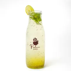A bottled lemon and mint cooler with chia seeds, shot against a white background to emphasize its freshness.