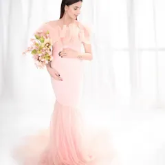 A vision in pink, this portrait features a stunning mermaid-style gown with a tulle train. The high-key lighting and soft colors create a sweet, romantic, and utterly dreamy image.