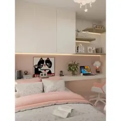 A cozy and chic girl's bedroom with a built-in desk and shelving. The soft pink and white color scheme, along with whimsical art, creates a dreamy and functional space.