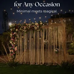 A minimal yet magical statement backdrop for any occasion, featuring a macrame curtain, disco balls, and a floral arrangement under string lights.