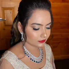 Ready for her Sangeet night, this client looks absolutely radiant. I gave her a glittery eyeshadow look with a classic red lip and glowing skin, which perfectly complements her diamond jewellery and elegant outfit.