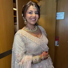 Another portrait of the bride, looking happy and confident. The soft makeup and elegant updo create a timeless and beautiful look.