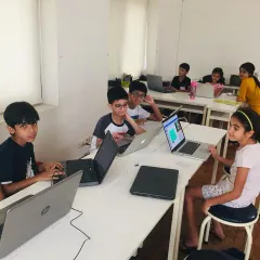 A candid shot of our classroom where young coders are busy with their projects. Our project-based curriculum keeps them focused and motivated as they learn key programming skills.