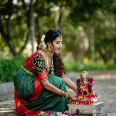 This is the same beautiful green and red saree, a classic choice for any festive pooja or ceremony.