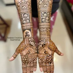 A beautiful bridal design combining traditional peacock motifs with delicate floral patterns and a blessed Ganesha figure. The full-arm coverage creates a stunning and complete look for the wedding day.