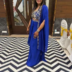 A full view of the client in the royal blue cape set, showcasing its contemporary design.