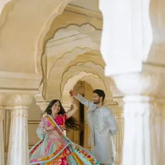 A playful twirl in the corridors of Amber Fort. The repeating arches create a beautiful sense of depth, and the bride's vibrant lehenga adds a splash of color to this classic pre-wedding photograph.