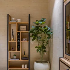 In the Director’s room, we designed this custom open shelf as a masterpiece of functional art. Paired with a lush green planter, it serves as a focal point and displays curated art pieces.