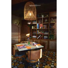 This cozy dining nook at Masia shows how lighting and texture create a warm, inviting atmosphere. I focused on the interplay between the wicker pendant lamp, the book-filled shelves, and the rustic furniture to capture the restaurant's character.