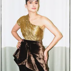 A closer look at the sculpted gold corset and deconstructed velvet skirt, showing the unique silhouette.