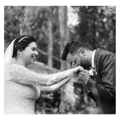 A tender gesture during the first look, as the groom kisses the bride's hand. The genuine smiles and laughter are what make these candid wedding photos so powerful.