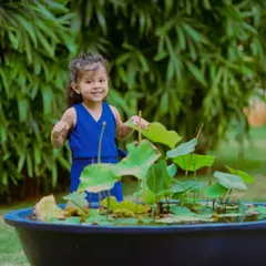 This shot captures the same little girl's infectious smile and happy energy. Outdoor sessions are perfect for letting toddlers move around and express themselves freely.