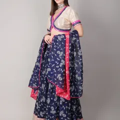 The model holds the dupatta, showing its generous length and vibrant print. Every element of the outfit is designed to add grace to your dance moves.