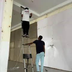 My team at work installing a dome camera in a commercial space. We use professional-grade ladders and equipment to work safely and efficiently, even with high ceilings.