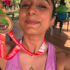 The proud moment holding my 10k finisher medal. I know what it takes to start from scratch and reach a big running goal, and I can guide you through the process.