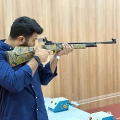 Mr. Omar Haris Nalapad takes aim with an air rifle. We welcome leaders and influencers to experience the sport and discover the mental benefits of precision shooting.