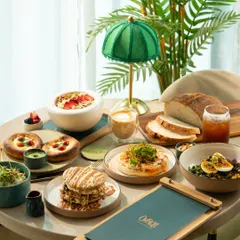 Another beautiful brunch table, shot from a slightly different angle. The variety of sweet and savory dishes shows the breadth of the menu.