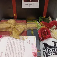 Another view of the 'first salary' gift box, showing the arrangement of the personalized letter, mug, and other items.