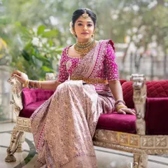 A full-length view of our bride's reception look. The custom-designed pink blouse and traditional silk saree create an elegant silhouette, showcasing how the final outfit comes together beautifully.