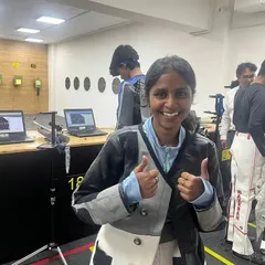 The joy of a good performance. A shooter gives a thumbs-up after her session, with our electronic targets displaying results in the background.
