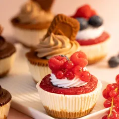 A close-up of my mini cheesecakes from the Rakhi collection. Featuring berry compote and Lotus Biscoff toppings, these are a perfect sweet treat for your sibling.