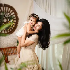 A sweet moment between a mother and her daughter. The soft, natural light and gentle embrace make this a truly heartwarming portrait.