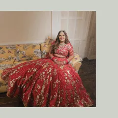 A full-length portrait showcasing the bride's stunningly detailed red lehenga. We ensure that every element of the bridal attire, which is chosen with so much love, is captured beautifully.