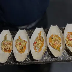 Our crispy Palak Patta Chaat is a delightful mix of textures and flavors. Each leaf is fried to perfection and topped with yogurt, chutneys, and sev, served in individual eco-friendly boats.