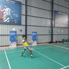 Another young athlete in action during the Yonex event at my academy. The professional setup, complete with branding from partners like Yonex and posters of stars like Lakshya Sen, inspires my players.