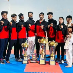 Our team of champions posing with their hard-earned trophies. This image represents the dedication, skill, and winning spirit that we cultivate at United Martial Arts Club.