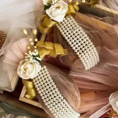 I love adding elegant and traditional touches like these pearl-studded bangles (gajras) to my trousseau designs, finished with a golden ribbon and a white rose.