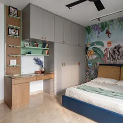 A jungle-themed kid's room designed for a modern loft. The vibrant wallpaper, custom study desk, and ample storage create a space that is both playful and functional, reflecting the child's love for animals.