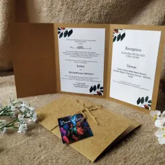A complete view of our kraft paper invitation suite. The inside panels clearly lay out the ceremony and reception details with minimalist leaf illustrations, while the custom photo tag adds a deeply personal touch.