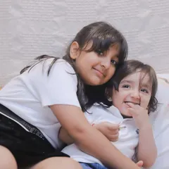 A sweet hug between siblings. We create a relaxed environment where kids can be affectionate and playful, resulting in authentic, heartwarming photos.