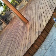 A freshly installed IPE wood deck. The rich color and natural grain of the wood add warmth and sophistication to this outdoor space. Our team ensures a perfect finish every time.