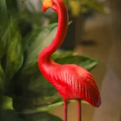 Add a pop of playful color to your urban jungle. This bright pink flamingo figurine stands tall among green foliage, bringing a fun, tropical accent to your indoor plant collection.