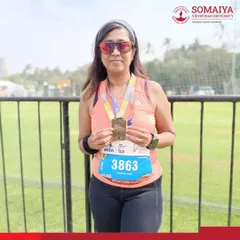 Dr. Vrushali Deole shows her finisher's medal after completing the 42 km Full Marathon at the Tata Mumbai Marathon 2026.